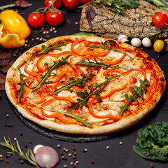 Top view pizza on table top, Flat lay of pizza on black background, Prepared pizza on table for serve Freshly baked homemade pizza isolated on a black background with vegetables. View from above