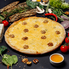 Top view pizza on table top, Flat lay of pizza on black background, Prepared pizza on table for serve Freshly baked homemade pizza isolated on a black background with vegetables. View from above