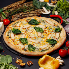 Top view pizza on table top, Flat lay of pizza on black background, Prepared pizza on table for serve Freshly baked homemade pizza isolated on a black background with vegetables. View from above