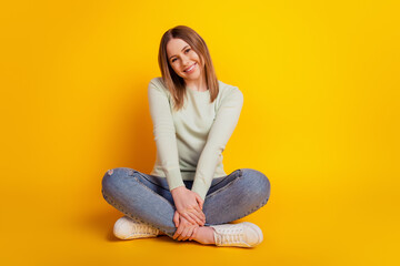 Photo of adorable funny positive lady sit floor enjoy rest wear green shirt jeans isolated on...