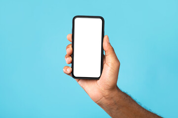 Unrecognizable black man showing cellphone with mockup, advertising app or website, promoting online product or service