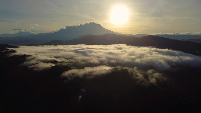 video of clouds over the hills with Mount Kinabalu as background