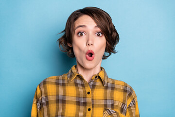 Obraz na płótnie Canvas Photo of pretty shocked funny girl open mouth wow reaction wear checkered shirt isolated blue color background