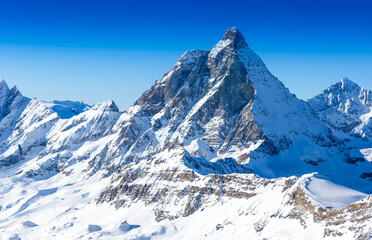 Ski slope and snow covered winter mountains. Matterhorn mountain in winter time