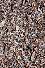 Wood chip bark chippings having been shredded for use as a garden mulch by the lumber timber industry which can be used as an abstract texture background, stock photo image