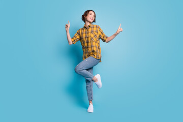 Fototapeta na wymiar Photo of carefree cute lady dance enjoy discotheque wear checkered shirt jeans shoes isolated blue color background