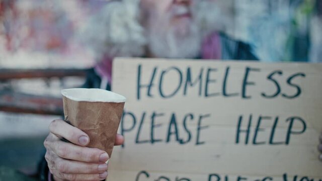 Kind Stranger Donating Money To Refugee On The Street, Putting Coin In Paper Cup