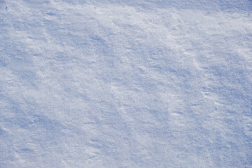 Texture of winter snow surface. Blue natural snow background.