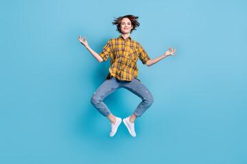 Obraz premium Photo of peaceful lady jump meditate enjoy flight wear plaid shirt jeans shoes isolated blue color background