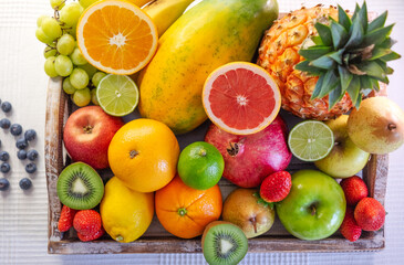 Above view of wooden basket full of fresh fruits and colors. Healthy lifestyle and eating