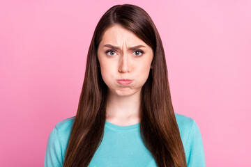 Photo of unhappy young stressed woman hold breath cheeks face isolated on pastel pink color...