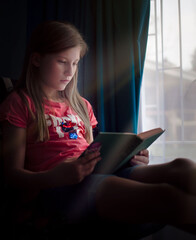 Young girl reading a book