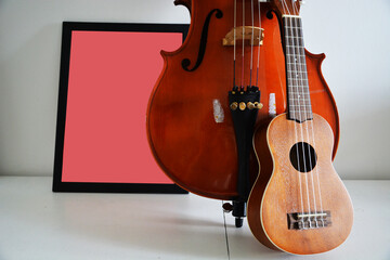 Fototapeta na wymiar Vintage cello and ukulele, empty poster for signs background 