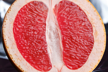 Half a grapefruit as an erotic concept. Symbolic image of the vagina of the hymen. Close-up. Selective focus - obrazy, fototapety, plakaty