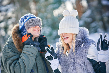 Couple having fun in winter scenery and snow