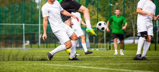 Group of Adult Soccer Players in a Duel. Footballers Kicking Match on Grass Field. Football Forward...