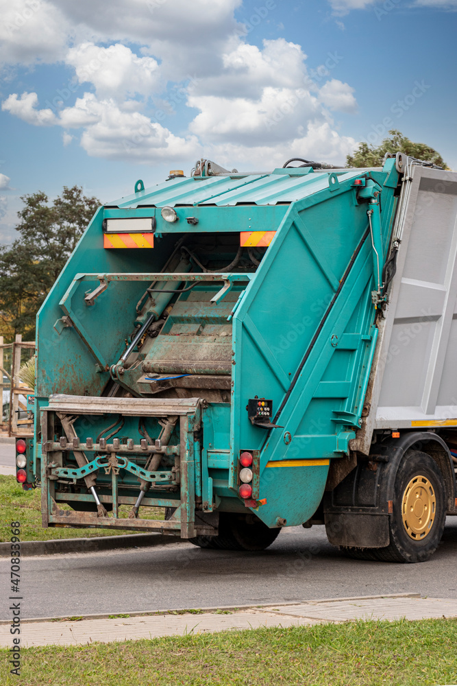 Aufkleber A garbage truck picks up garbage in a residential area. Separate collection and disposal of garbage. Garbage collection vehicle.
