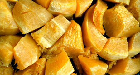 baked pumpkin background. bright orange pumpkin slices with a fibrous structure. healthy nutrition, the concept of vegetarianism. lifestyle. vitamins and fiber. energy for a person. copy space.