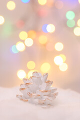 christmas decoration white cone in snow with christas light bokeh i background