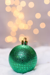 green christmas decoration ball with light bokeh background