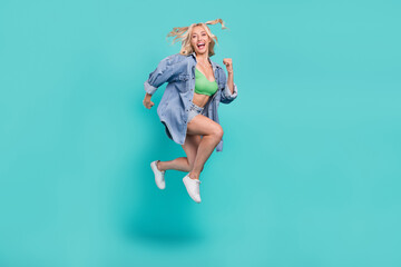 Full length photo of happy young positive woman jump up enjoy summer cool isolated on blue color background