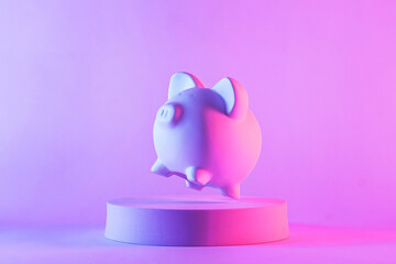 Studio close-up of piggy bank floating above a round podium