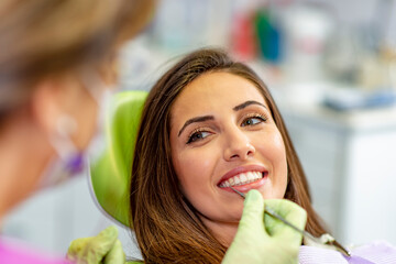 Smiling young woman at the dentist chair