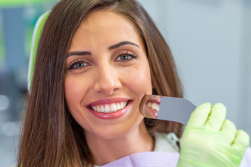 Smiling young woman at the dentist chair