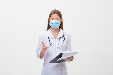 Portrait of female doctor or nurse weares mask with stethoscope amd folder on white background.