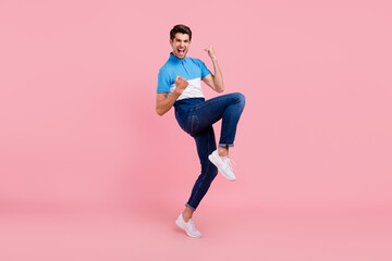 Fototapeta na wymiar Full length photo of hooray brunet young guy stand wear polo jeans sneakers isolated on pink background