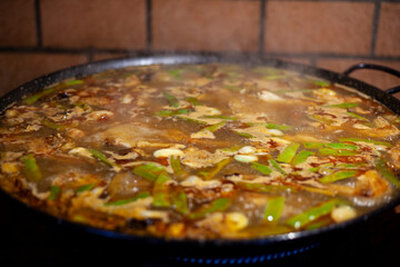 
preparation of typical Valencian paella