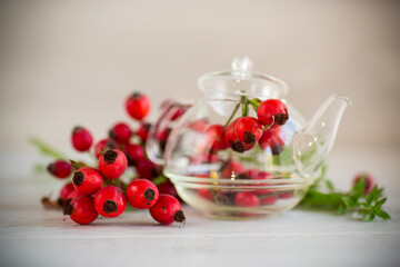 ripe red rose hips on a wooden table