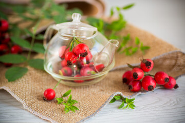 ripe red rose hips on a wooden table