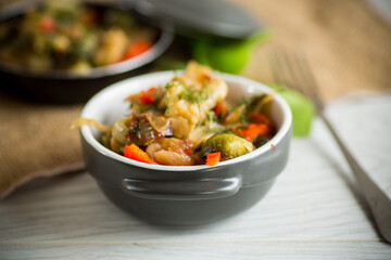 fried brussels sprouts with cauliflower and other vegetables in a bowl