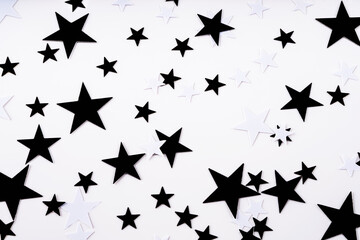 Confetti black and white stars on a white background.