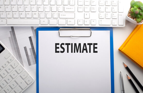 ESTIMATE written on the paper with keyboard, chart, calculator and notebook