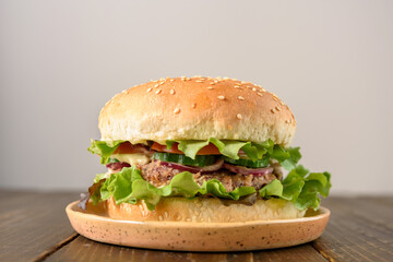 Vegetarian burger with bean patty on wooden table