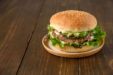 Vegetarian burger with bean patty on wooden table