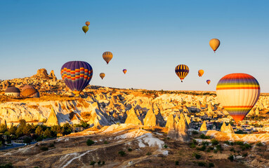 Hot air balloons in beautiful Cappadocia, Turkey ready to take to the sky. Amazing view on ancient valley