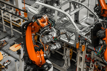 Car bodies are on assembly line. Factory for production of cars. Modern automotive industry. Electric car factory, conveyor