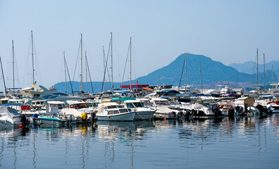 Yachts port in Montenegro with mountains view in adriatic sea. Boats pier in sunny day with beautiful nature