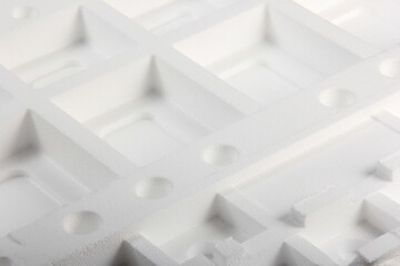 Styrofoam Sheets of different shapes on white background. Pieces of white styrofoam close up....