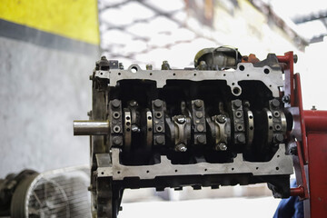 the hand of a mechanic is installing the valve seal of an overhauled car engine