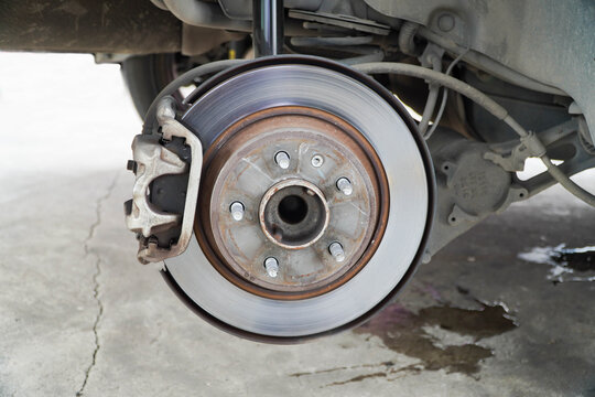 Disc brake of the vehicle for repair,Seal a leaking car tire.Car brake repairing in garage.