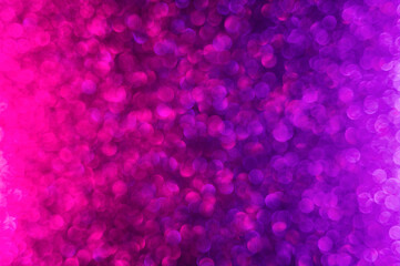 Abstract neon purple and pink gradient glitter background. Great backdrop for any holiday or event. Bokeh light overlay. Color gradient glow.