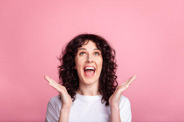 Photo of young excited woman amazed surprised omg wow unexpected news isolated over pink color background