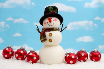 Happy snowman with hat, ornaments, and snow with sky