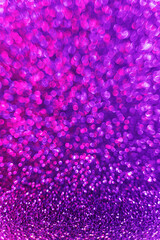 Abstract neon purple and pink gradient glitter background. Great backdrop for any holiday or event. Bokeh light overlay. Color gradient glow.