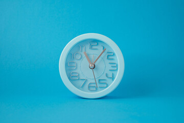 desktop classic clock alarm clock isolated on blue background
