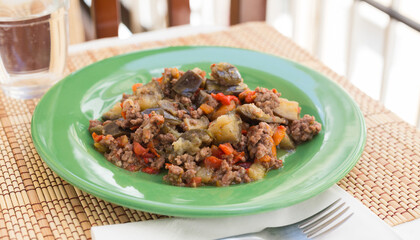 dish of vegetable stew. stewed eggplant, minced meat, carrots, peppers, onion squid